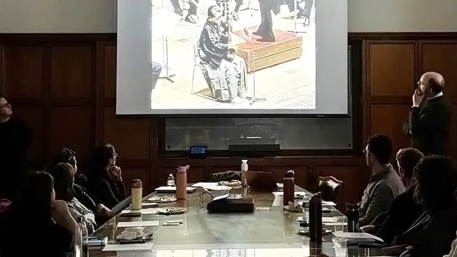 Dark classroom with professor talking to students